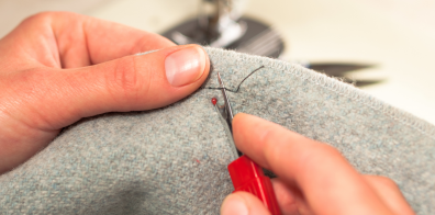 a person using a seam ripper on a fabric