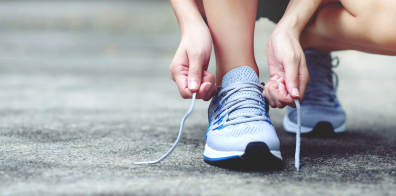 a person tying up their running shoes