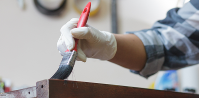 Person painting furniture 