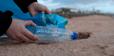 Person holding clear plastic bottle 