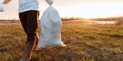 Man litter picking at sunset