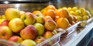 Apples, oranges and lemons in three plastic trays